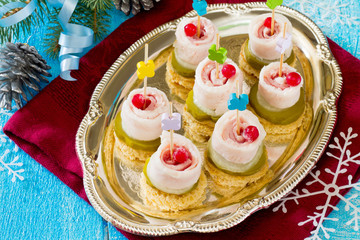 Appetizer canape with bacon and cucumber New Year's Eve