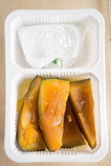 Pumpkin with coconut milk in takeaway box