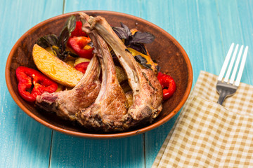 roasted ribs of lamb on ceramic plate