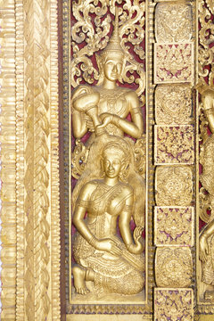 Carved wooden gate at the temple in Luang Prabang, Laos.