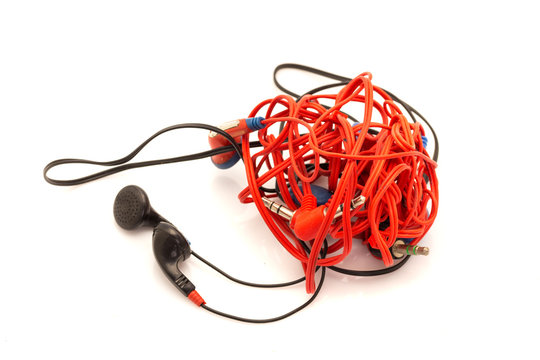 tangeled various headphones isolated on white