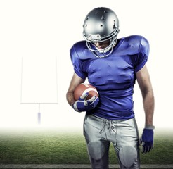 Composite image of american football player looking down