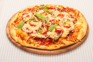 Delicious pizza served on wooden plate