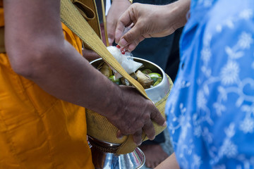  Buddhist monks are given food offering from people for End of Buddhist Lent Day