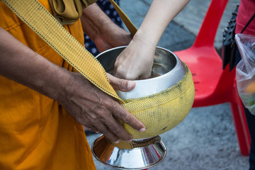  Buddhist monks are given food offering from people for End of Buddhist Lent Day