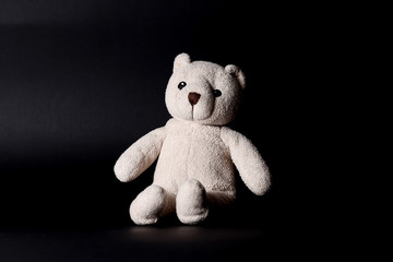 Brown teddy-bear on black background