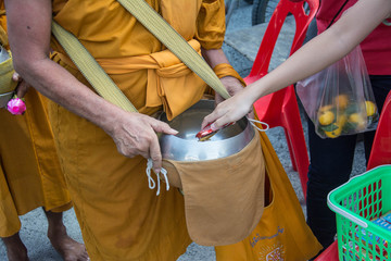  Buddhist monks are given food offering from people for End of Buddhist Lent Day