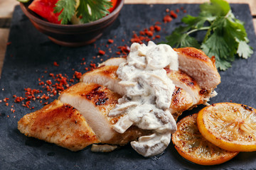 roast chicken breast with mushroom sauce and lemon 