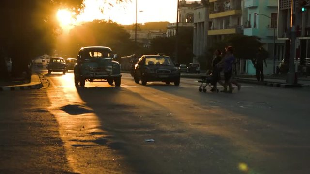 Row of classic cars in the sunset glow in Havana