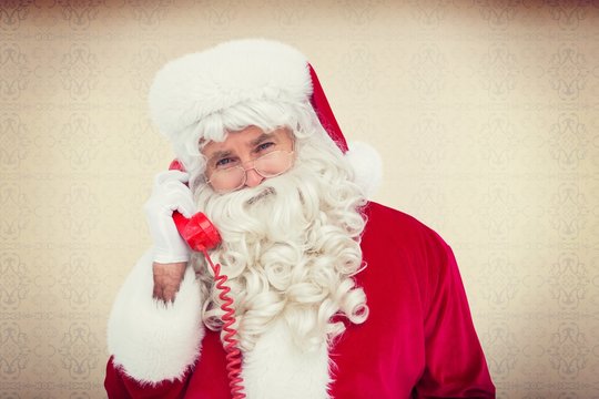Composite image of santa claus on the phone 