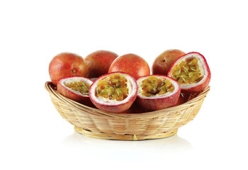 Passion fruit in wicker basket isolated on white