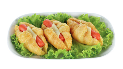 Croissant with sausage and lettuce isolated on white background