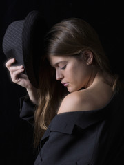 Fototapeta premium Portrait of a young woman in a hat