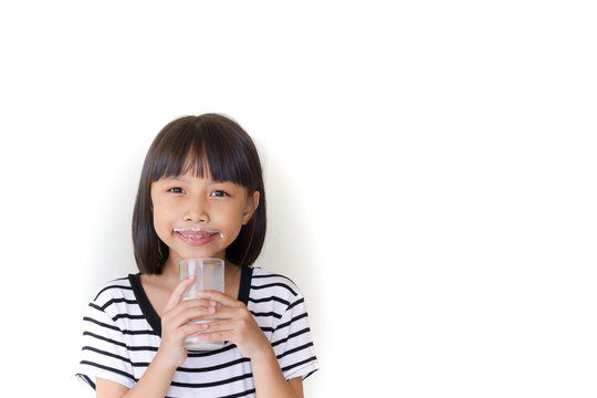 Gorgeous little girl wearing striped encouraged to drink milk