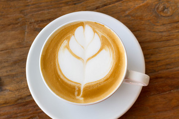 hot milk art coffee on wooden table