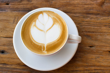 hot milk art coffee on wooden table