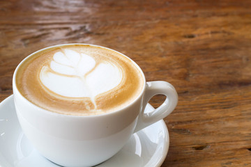 hot milk art coffee on wooden table