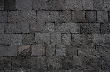 
wall background of volcanic basalt stone texture - architecture background