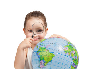 beautiful cute little girl examining globe with magnifying glass