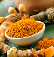 turmeric roots in the basket on wooden table