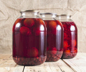 Fruit compote in glass jars on a wooden table