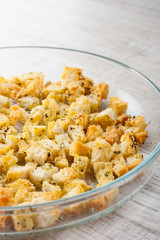 Small croutons with pepper  on the glass  dish at the left of the table