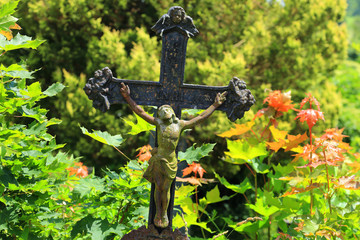 Jesus in colorful autumn Nature from the old village Cemetery, Czech Republic