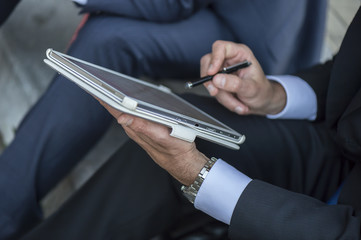 Close up of a businessman using a digital tablet