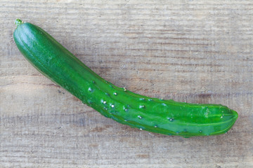 Fresh green cucumber on wood chopping block background
