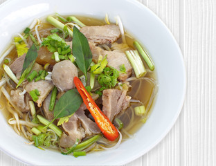 Beef Stew Noodle Soup and fresh vegetable on wood table..