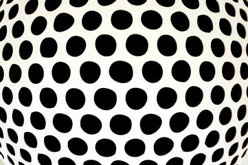 Black polka dot in big white circle.