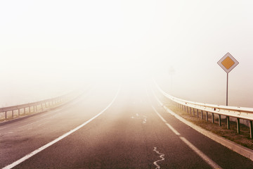 Autumn misty road