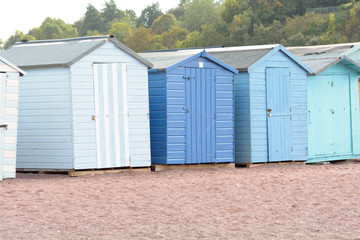 Fototapeta na wymiar A row of wooden beach huts in Teignmouth, Devon, England