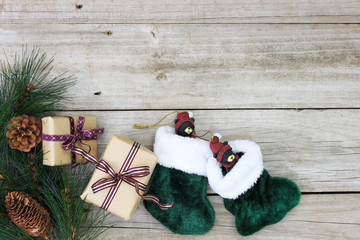 Presents, Christmas stockings and garland on rustic wood background