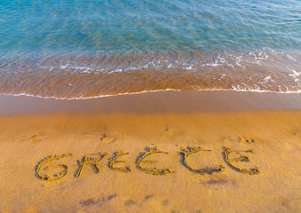 the name of GREECE written on the sand of Kardamaina beach at Kos island in Greece
