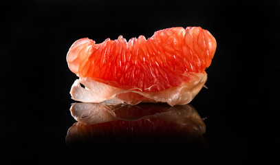 Grapefruit slice on black background