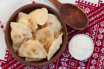Dumplings with bacon on embroidered tablecloth
