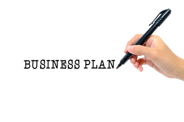 Hand holding pen writing words business plan concept.
