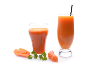 Carrot juice and slices of carrot on white