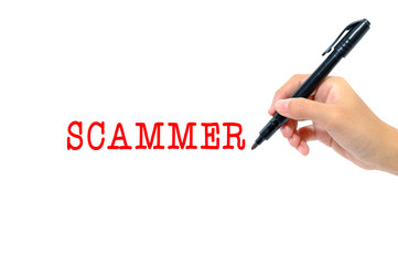 Hand holding pen writing words scammer concept.