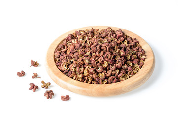 dry pink pepper in the wooden plate