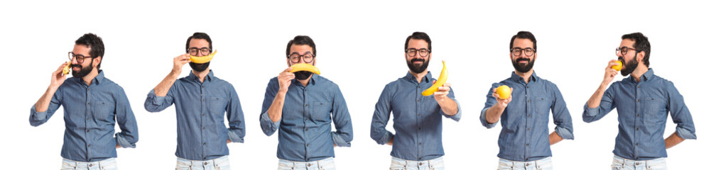 Happy young hipster man with banana