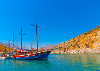 traditional wooden big sailing boat  docked at the port of Vathi village in Kalymnos island in...
