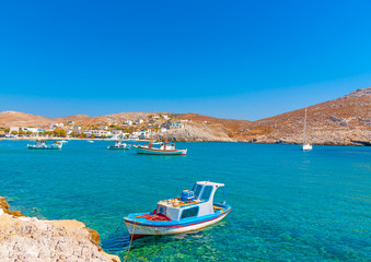 Fototapeta na wymiar traditional fishing boats docked in the port of Pserimos island in Greece
