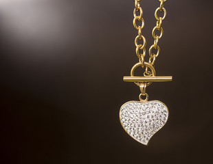 Gold necklace with a heart © jandix2