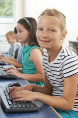 Group Of Elementary School Children In Computer Class