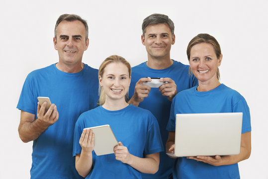 Studio Portrait Of IT Support Staff Wearing Uniform Against Whit