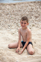 Kid playing on the beach in a sunny day.