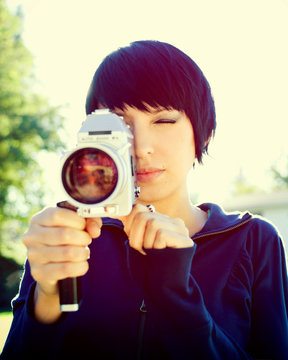 A Young Woman Filmmaker Shooting With A Vintage 8 Mm Camera.