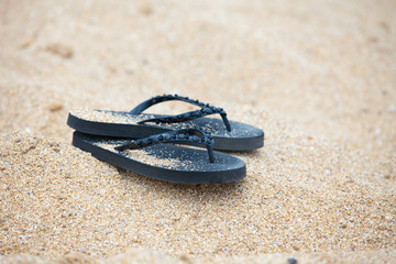 Fototapeta na wymiar Flip Flops on a Sandy Beach